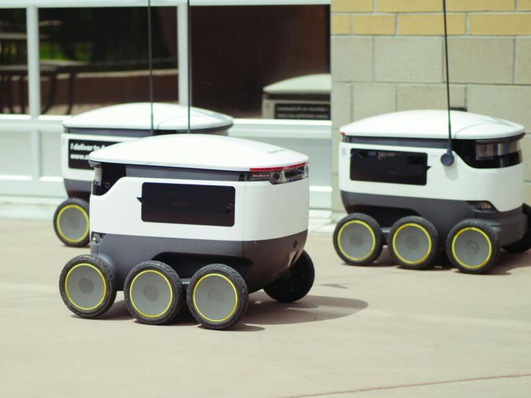 Advanced autonomous delivery robots in an outdoor urban setting, showcasing modern technology.